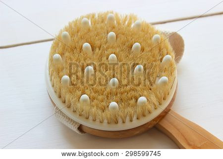 Close-up Of Wooden Massage Brush Isolated On White Background. Brush For Dry Massage. Anti-cellulite
