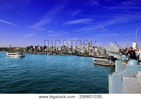 Istanbul, Galata Bridge / Turkey, 04.21.2019: Galata Bridge Fisherman View, Galata Tower, Bright Sky