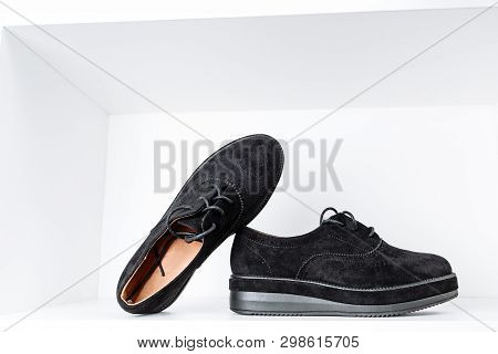 A Pair Of Black Shoes On Thick Soles On A White Background