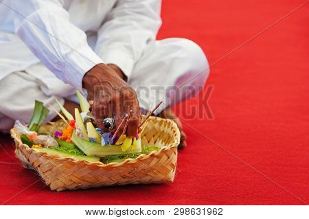 In Hindu Temple Priest Mangku Praying And Making Offerings Ritual Before Traditional Balinese New Ye