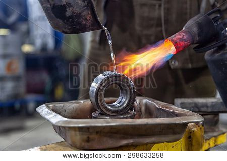 Professional Male Worker Using A Gas Torch To Melt Lead Metal. Close-up A Gas Burner With A Fire Aim