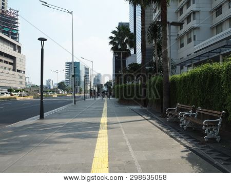 Jakarta, Indonesia - April 17, 2019: Pedestrian Sidewalk On Thamrin Street With Background Of Modern