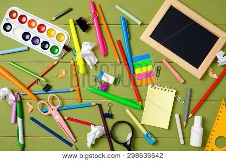 Messy And Cluttered Kids Desk With School Supplies. Education, Studying And Back To School Concept. 