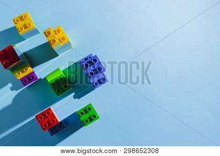 Multicolored Details From The Childrens Designer On A Blue Background. Flat Lay, Top View.