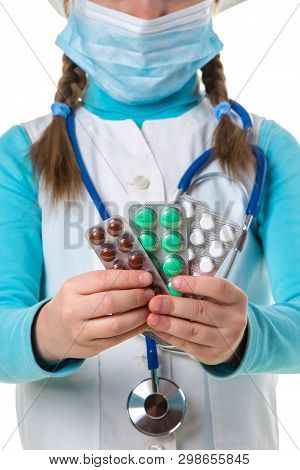 Pharmacist Female In White Robe And Madical Mask, Stathoscope Holding Many Colorful Pills And Tablet