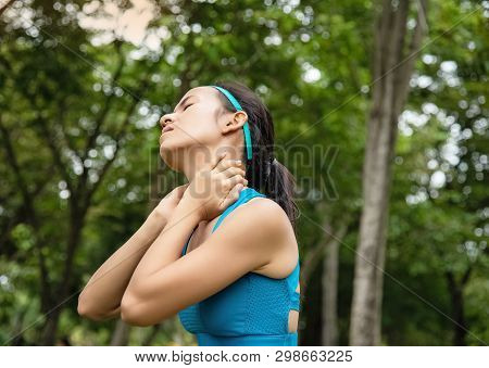Woman Wearing Exercise Suit,put Hands Touch Her Neck,a Stiff Neck From Exercise,relieve Pain,uncomfo
