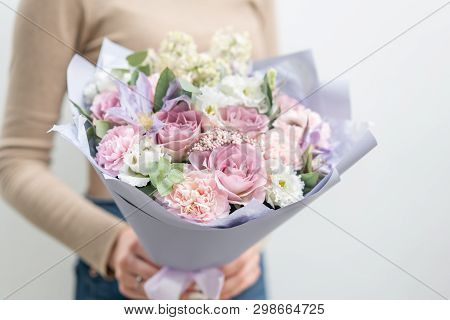 Beautiful Bouquet Of Mixed Flowers In Woman Hand. The Work Of The Florist At A Flower Shop. Delicate