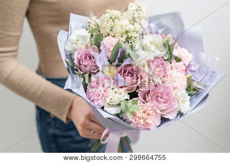 Beautiful Bouquet Of Mixed Flowers In Woman Hand. The Work Of The Florist At A Flower Shop. Delicate