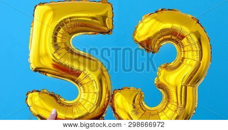 Gold Foil Number 53 Celebration Balloon On A Blue Background