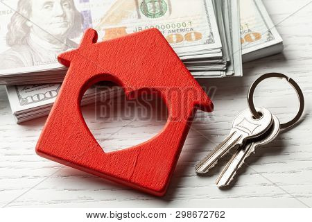 Wooden Hut With Money And Keys On A White Background. Buying Or Renting Or Selling. Concept Remont O