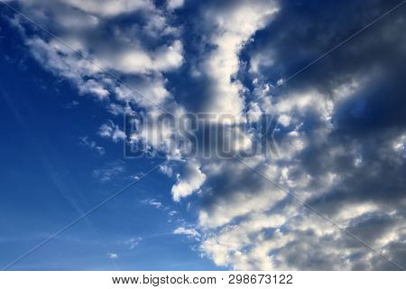 Beautiful Mixed Cloud Formations With White And Grey Cumulus Clouds In The Sunlight On A Blue Sky Se