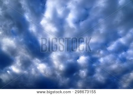 Beautiful Mixed Cloud Formations With White And Grey Cumulus Clouds In The Sunlight On A Blue Sky Se