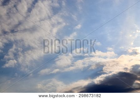 Beautiful Mixed Cloud Formations With White And Grey Cumulus Clouds In The Sunlight On A Blue Sky Se