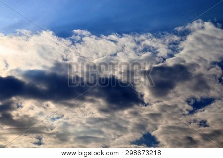 Beautiful Mixed Cloud Formations With White And Grey Cumulus Clouds In The Sunlight On A Blue Sky Se