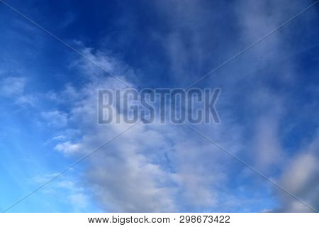 Beautiful Mixed Cloud Formations With White And Grey Cumulus Clouds In The Sunlight On A Blue Sky Se