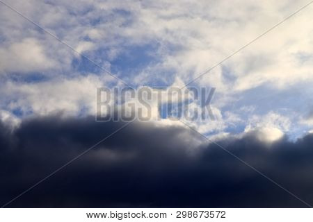 Beautiful Mixed Cloud Formations With White And Grey Cumulus Clouds In The Sunlight On A Blue Sky Se
