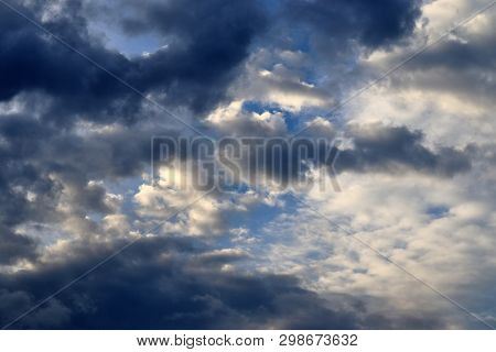 Beautiful Mixed Cloud Formations With White And Grey Cumulus Clouds In The Sunlight On A Blue Sky Se