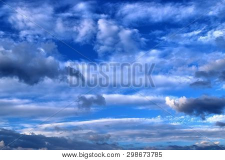 Beautiful Mixed Cloud Formations With White And Grey Cumulus Clouds In The Sunlight On A Blue Sky Se