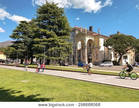 Luino, Lombardy, Italy - April 30, 2019: People Walking Along The Luino, Lakefront On The Coast Of L