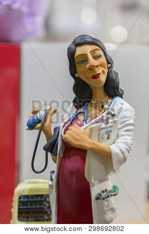 Beautiful Porcelain Figurine Of A Female Doctor. Ertical Photo