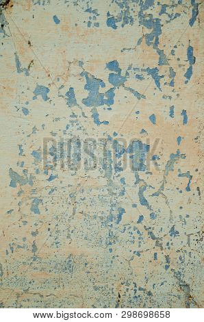 Close-up Of Wall Covered By Rough Plaster With Some Cracks And Chipped, Forming A Singular Pattern A