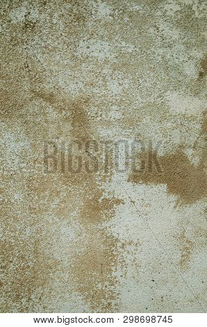 Close-up Of Worn Wall Covered By Rough Plaster With Some Chipped, Forming A Singular Pattern At Unha