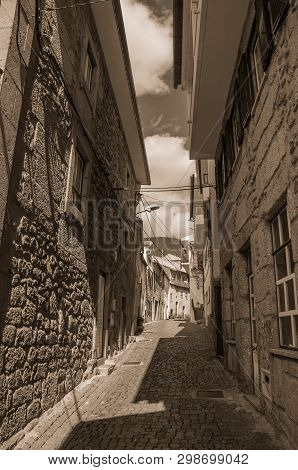 Narrow Deserted Alley And Old Houses With Stone Wall At Unhais Da Serra. A Small And Graceful Villag