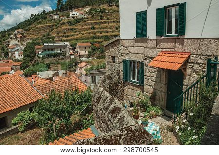Facade Of Neat House And Hilly Landscape With Trees And Terraced Fields, In A Sunny Day At Alvoco Da