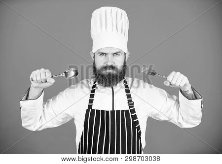 Hungry Chef Ready To Try Food. Time To Try Taste. Chef Serious Strict Face Hold Spoon And Fork. Man 