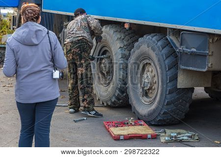 Milkovo, Russia- 27 September 2014: Russian Off-road Extreme Expedition Blue Truck, A Man Repairing 