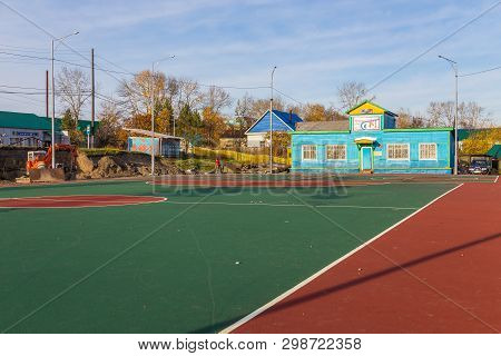 Milkovo, Kamchatka, Russia- 27 September 2014: View Of The Sports Field, Blue Wooden Building In The