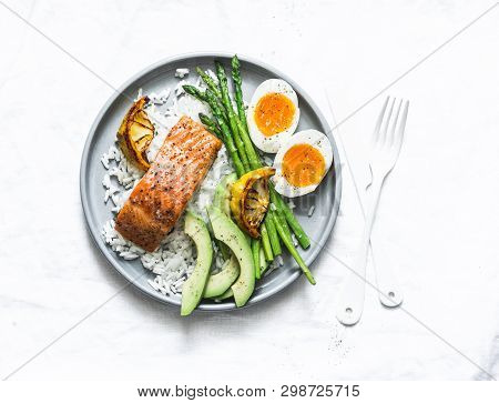 Healthy Delicious Balanced Lunch - Baked Salmon, Rice, Asparagus, Avocado And Boiled Egg On A Light 