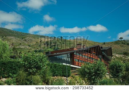 Unhais Da Serra, Portugal, July 15, 2018. Hotel Facade In Hilly Landscape Covered By Brushes At Unha