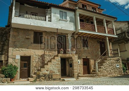 Unhais Da Serra, Portugal - July 15, 2018. Old Stone Two-story House With Wooden Door, In An Alley A
