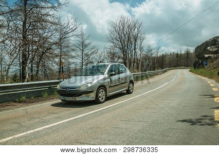 Serra Da Estrela, Portugal - July 18, 2018. Car Passing Through A Road In Burnt Forest At The Serra 