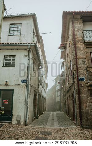 Guarda, Portugal - July 20, 2018. Old Terraced Houses And Narrow Deserted Alley, In The Morning Mist