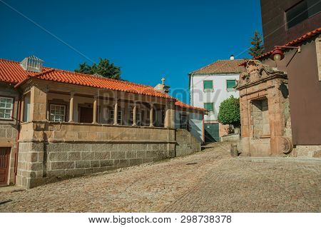 Guarda, Portugal - July 21, 2018. Deserted Alley And Stone Old House With Charming Gothic Porch At G