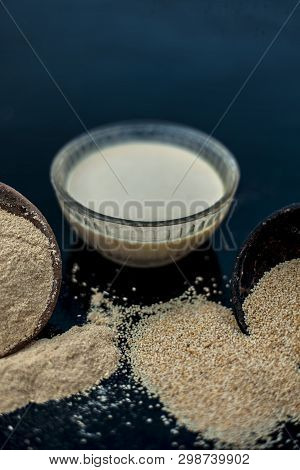Clay Bowl On Wooden Surface Full Of Poppy Seeds Or Khus Or Opium Poppy Or Bread Seed Poppy With Its 