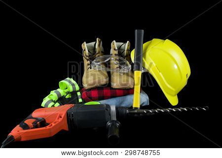 Work Tools For Construction Worker  On Black Background.yellow Crash Helmet, Red Checkered Shirt, Je