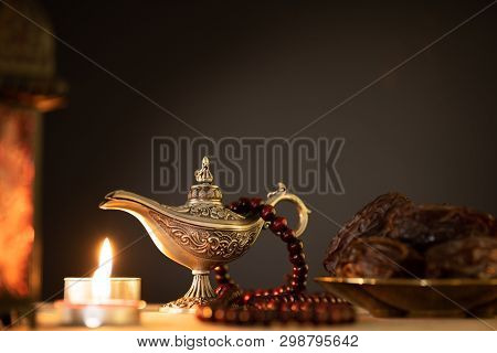 Ramadan Food And Drinks Concept. Ramadan Lantern With Arabian Lamp, Wood Rosary, Tea, Dates Fruit An