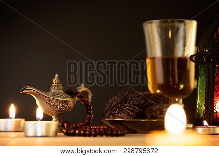 Ramadan Food And Drinks Concept. Ramadan Lantern With Arabian Lamp, Wood Rosary, Tea, Dates Fruit An