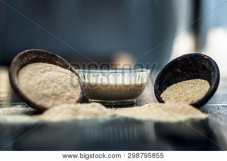 Clay Bowl On Wooden Surface Full Of Poppy Seeds Or Khus Or Opium Poppy Or Bread Seed Poppy With Its 