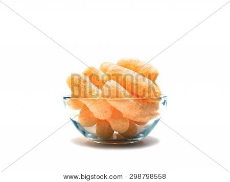 Yellow Corn Puffs In A Glass Bowl Isolated On White Background. Crunchy Flavored Puffed Snacks. Part