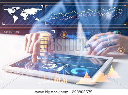 Stockbroker Working With Financial Information At Tablet Computer. Interactive Stock Market Tracking