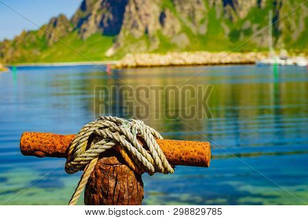 Harbor Marina Detail. Old Rusty Mooring Bollard With Rope. Bleik Village, Andoya Island, Vesteralen 