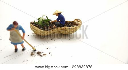 Conceptual Illustration, Keep Struggle, Mini Figure Man Farming At Limited Area, Peanut Skin, With W