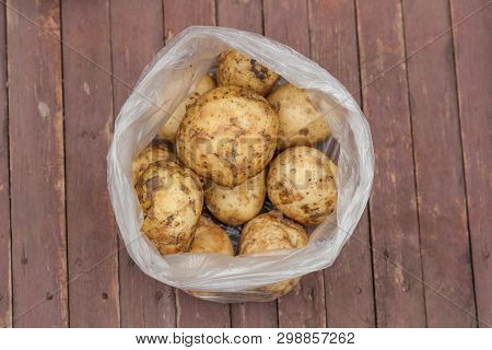 Potatoes In A Bowl On Wooden Table