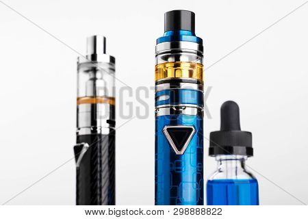 Electronic Cigarettes And Bottle With Vape Liquid On White Background