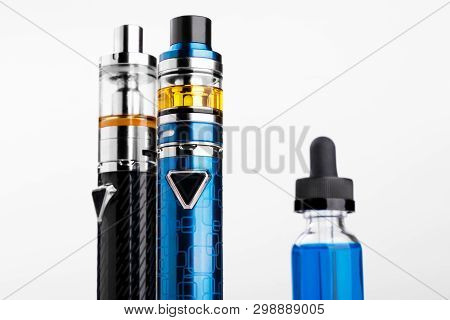 Electronic Cigarettes And Bottle With Vape Liquid On White Background