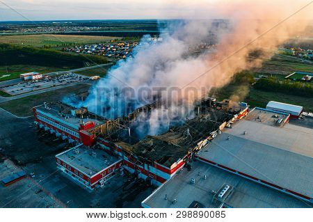 Heavy Smoke In Burning Industrial Warehouse Or Storehouse Industrial Hangar From Burned Roof, Aerial